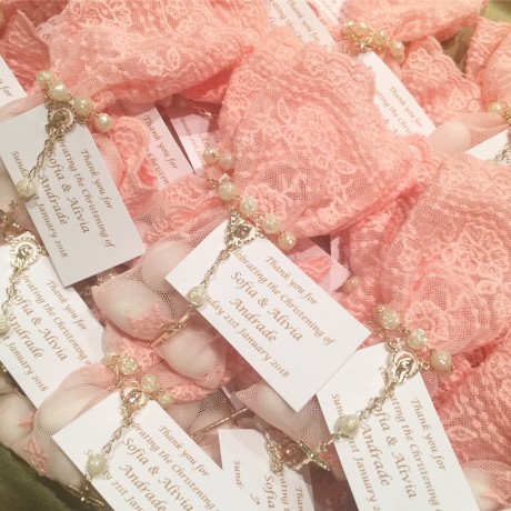 Coral-pink lace bonbonniere bags with mini rosary bead